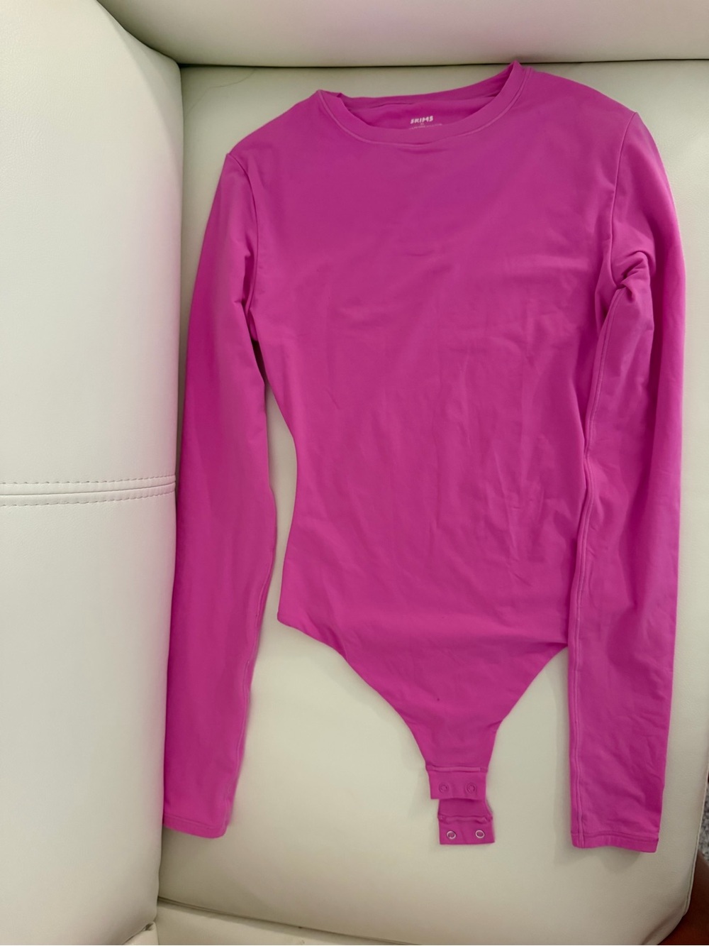 SKIMS Kids Long-Sleeve One-Piece Bodysuit in Hot Pink - Picture 2 of 4